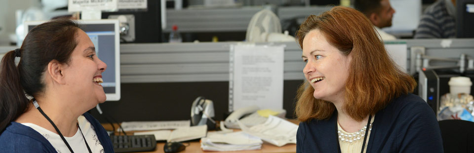 Staff talking in office