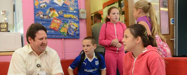Inspector speaking to children