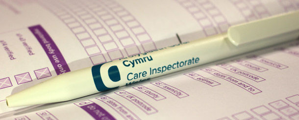 Care Inspectorate Wales pen lying on registration application form