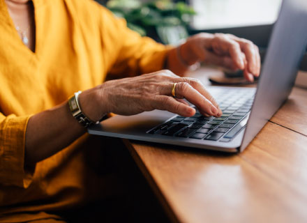 hands using laptop