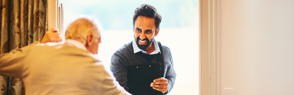 Senior man welcoming a healthcare worker