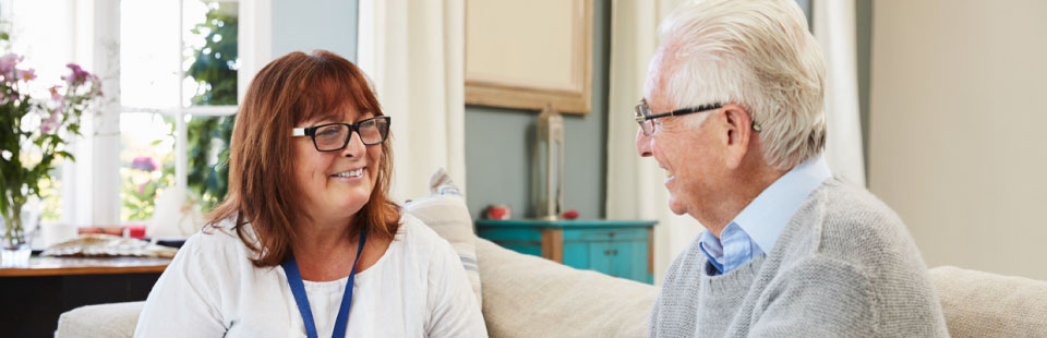 Female Support Worker Visits Senior Man At Home