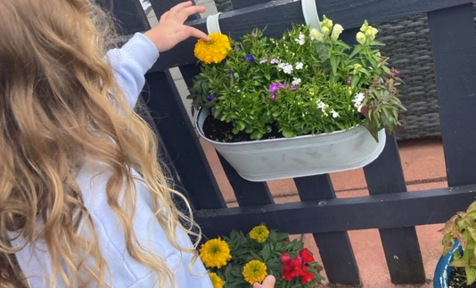 Child tending to flowers